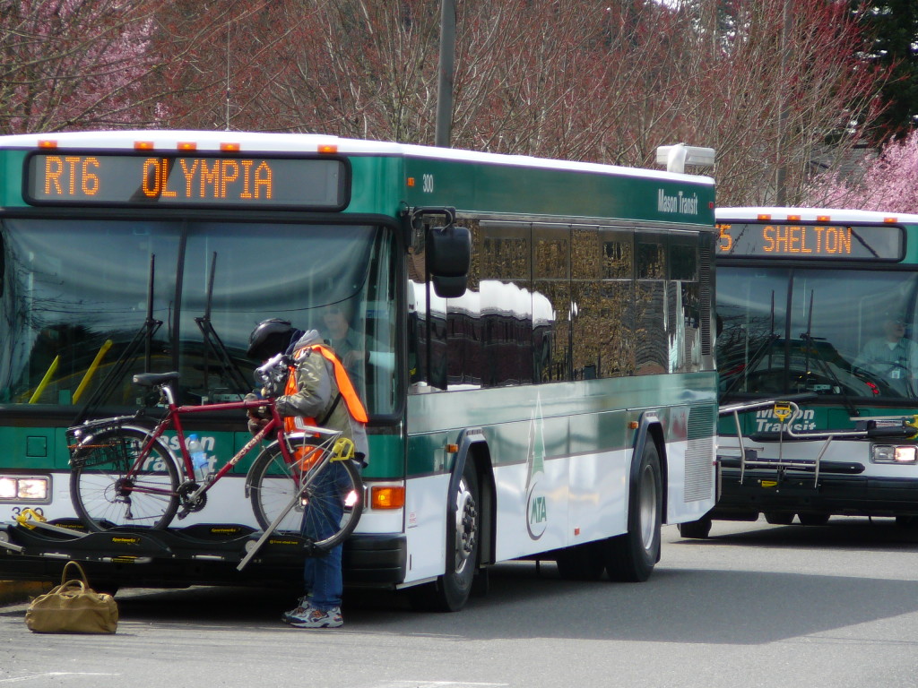 Person loading their bicycle on an MTA bus heading to Olympia.